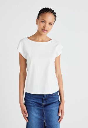 White short-sleeve t-shirt made of cotton with a wide neckline and relaxed fit, paired with a blue denim skirt featuring a front slit.