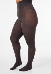 Collant neri opachi con una fascia alta in vita, texture liscia e copertura completa del piede, che mostrano un design senza cuciture dalla vita alla caviglia.
