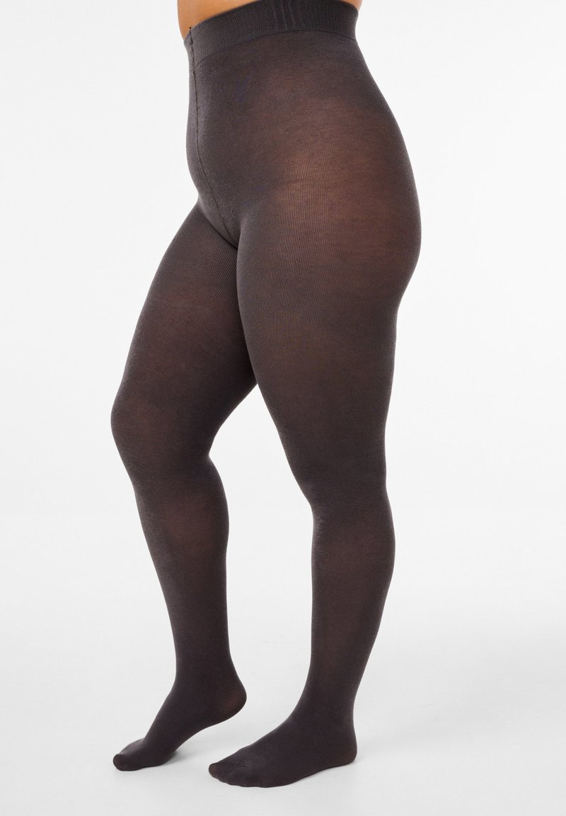 Collant neri opachi con una fascia alta in vita, texture liscia e copertura completa del piede, che mostrano un design senza cuciture dalla vita alla caviglia.