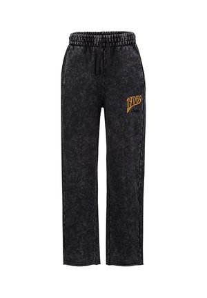 Zwarte gewassen sweatpants met elastische tailleband, trekkoord en gele "19769" tekst op de bovenste linker dij.