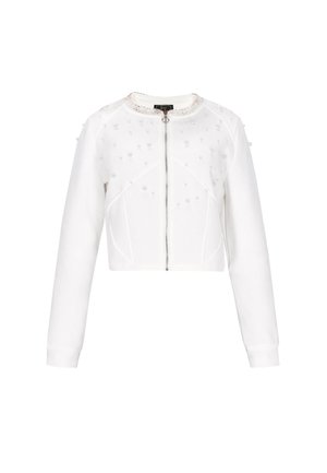 Veste blanche courte à manches longues ; dotée d'une fermeture éclair et d'embellissements décoratifs en perles sur le buste. Texture lisse, coupe ajustée.