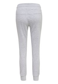 Pantalon de survêtement slim gris clair avec taille élastique et chevilles côtelées, vu de dos sur fond blanc.
