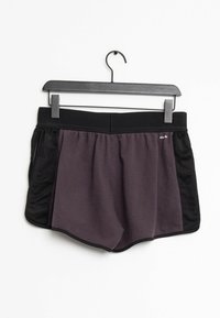 Black and purple athletic shorts with an elastic waistband and a loose fit. Features side pockets and contrasts in fabric texture.