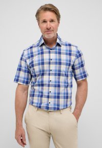 Korte mouwen geruite shirt in blauw, geel en crème. Heeft een knoopsluiting aan de voorkant, een kraag en een klein borstzakje. Gladde stofstructuur.