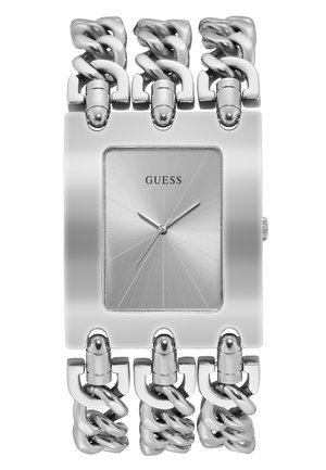 Montre rectangulaire argentée avec un cadran en métal brossé et un bracelet en maillons. Présente des index horaires subtils et un logo au centre.