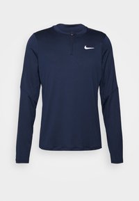Sinivärvi, pikaeelse krae ja valge Nike logo rinnal, sportlik särk pikade varrukatega, millel on sile ja sujuv kangas.