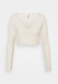 Langärmliges Wickeltop aus off-weißem Rippstoff mit V-Ausschnitt und kurzem Schnitt. Schlichte Ausführung ohne zusätzliche Muster.