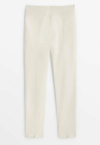 Pantalon slim taille haute couleur crème avec coutures sur le devant et zips aux ourlets des chevilles, présenté sur fond blanc.