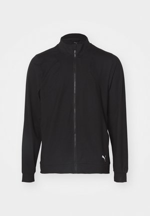 Črna športna jakna iz gladkega materiala, z visokim ovratnikom, polnim zadrgo in rebrastimi manšetami. Akcent logotipa pri robu.