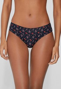 Granatowe figi bikini z wzorem cukrowej laski i kwiatów, wykonane z gładkiej, elastycznej tkaniny o średnim stanie.