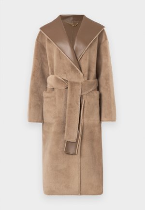 Beige, plush robe with a wide, brown leather shawl collar and a matching belt. Features side pockets and a soft, textured finish.