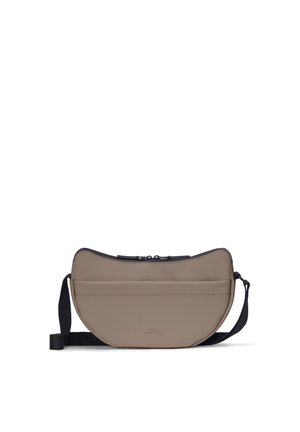 Taupe crescent-shaped crossbody bag with black adjustable strap and top zipper closure on a white background.