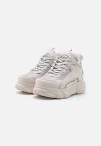 Köni sneakers heleda beežiga, millel on võrkkangas ja nahk, ümar nina, hallid aktsendid, paks pehmendatud tallad ja tooni järgi paela.