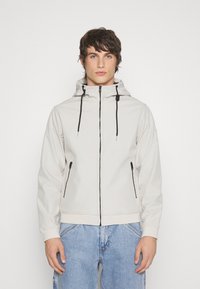 Light gray zip-up jacket with a hood, two side pockets with black zippers, and adjustable drawstrings; smooth texture and fitted design.