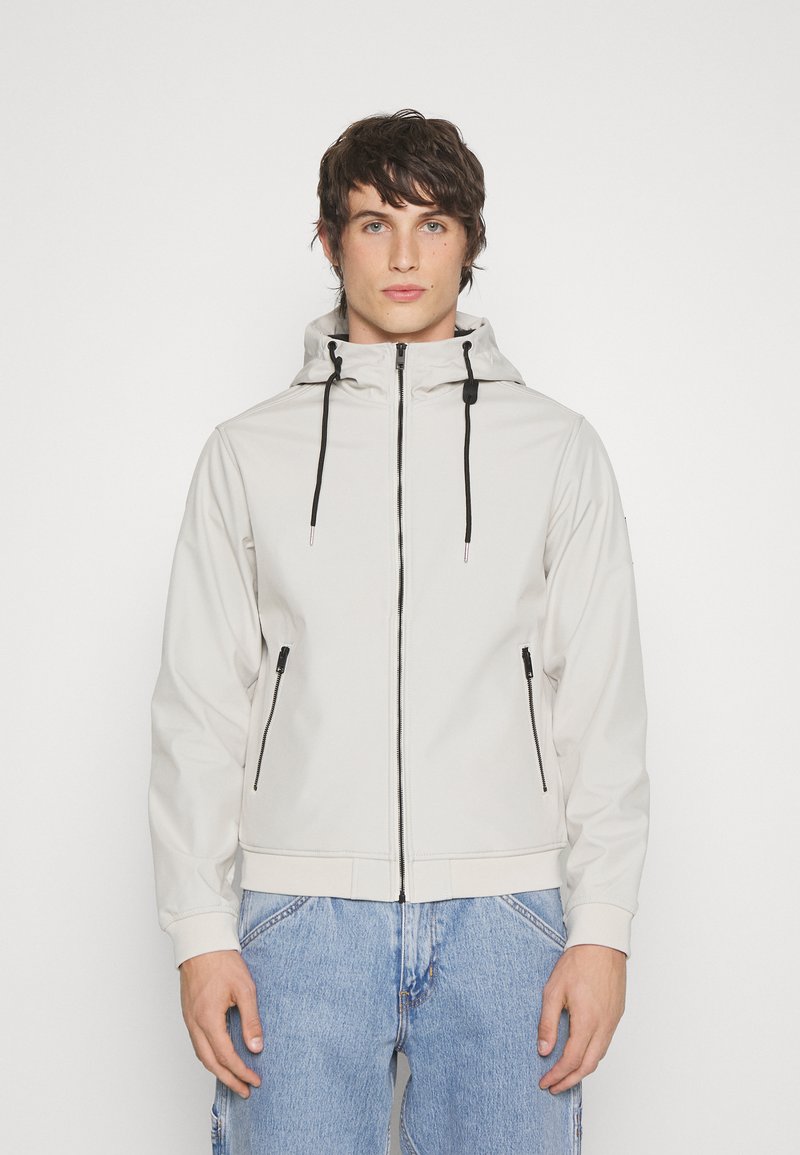 Light gray zip-up jacket with a hood, two side pockets with black zippers, and adjustable drawstrings; smooth texture and fitted design.