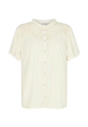 Cremefarbene Bluse mit kurzen Rüschensäumen, durchgehender Knopfleiste und strukturierten Stickereien über der Brust. Weicher, leichter Stoff.