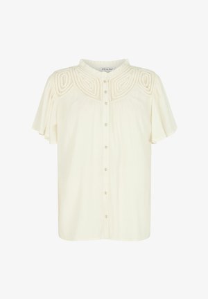 Cremefarbene Bluse mit kurzen Rüschensäumen, durchgehender Knopfleiste und strukturierten Stickereien über der Brust. Weicher, leichter Stoff.