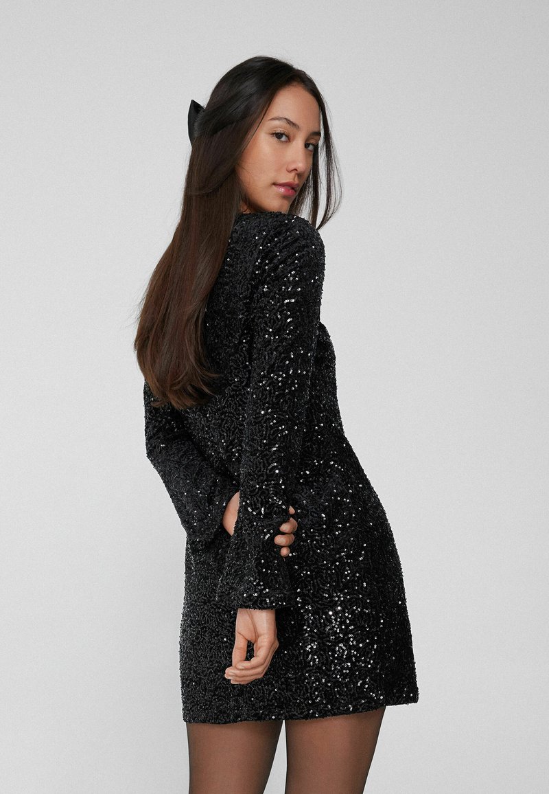 black sequin dress with black tights The perfect little black dress for every occasion and my secret weapon tights that hold it all together, via @saks #sakspartner #saks , Comment SHOP below to receive a DM with the link to this post on