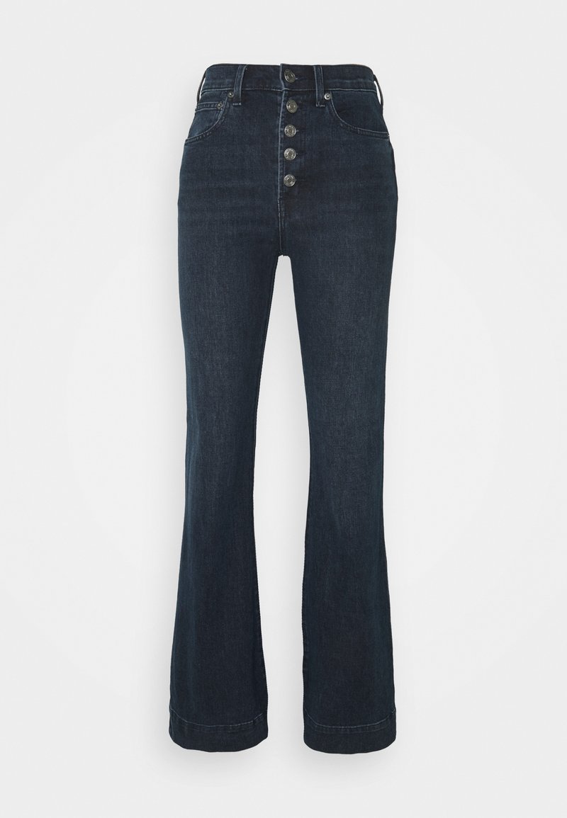 Jean bleu foncé taille haute avec cinq boutons métalliques, poches avant et jambes évasées, présenté sur un fond blanc uni.