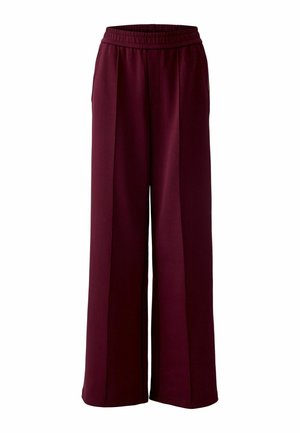 Pantalons larges bordeaux avec une taille élastique et des poches latérales, fabriqués en tissu doux avec une texture lisse et des lignes épurées.