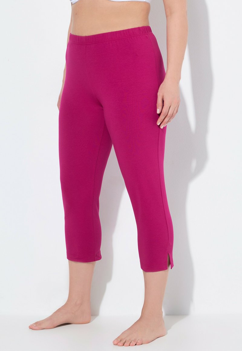 Magenta capri leggings with an elastic waist, cut-out side slits, and a smooth texture, designed for comfort and mobility.