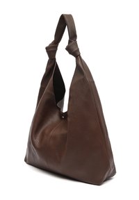 Pruun nahast õlakott tekstuurse pinnaga, sõlmitud käepidemetega ja mahuka kujuga. Omaduseks on ühe klõpsluku sulgemine ning nähtamatud metalldetailid.