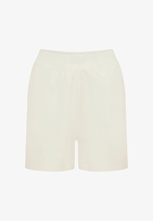 Jasnobeżowe szorty z miękkiego materiału, z elastycznym pasem i luźnym krojem, bez widocznych wzorów czy ozdób.