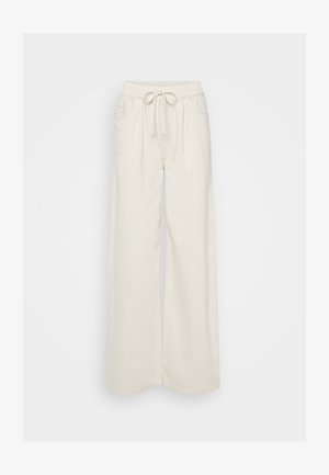 Kremfargede vide bukser laget av mykt stoff med elastisk midje og snøring. Har to sidelommer.