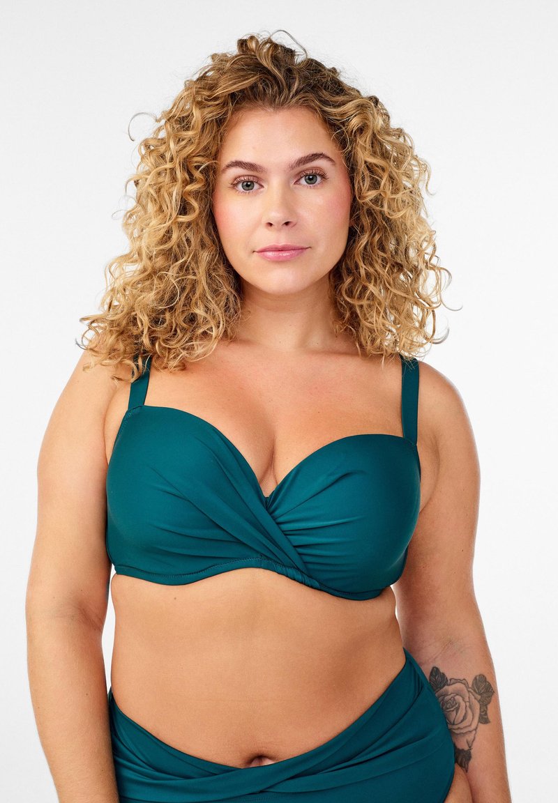 Türkisfarbener Bikini-Oberteil mit gedrehtem Vorderteil, verstellbaren Trägern und weichem, strukturiertem Stoff. Verfügt über eine klassische, gut sitzende Silhouette.