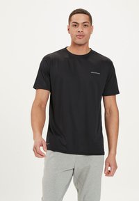 Schwarzes Sport-T-Shirt aus glattem, leichtem Stoff. Mit kurzen Ärmeln, rundem Halsausschnitt und einem dezenten Logo auf der Vorderseite.