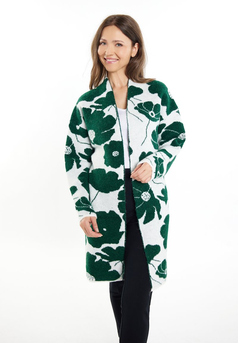 Gebreide cardigan met een witte basis en grote groene bloempatronen, open ontwerp aan de voorkant, lange mouwen en een zachte textuur.