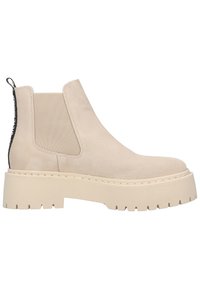 Bottine en daim beige avec panneaux latéraux élastiques, semelle plateforme épaisse beige clair, et languette noire à l'arrière.
