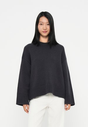 Dark gray knitted sweater with a crew neckline, wide sleeves, and ribbed hem. Made from textured fabric, featuring a loose fit and dropped shoulders.