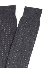 Calzini grigi scuri con un bordo a coste, caratterizzati da un motivo a pois grigio chiaro, realizzati in un morbido tessuto lavorato a maglia.