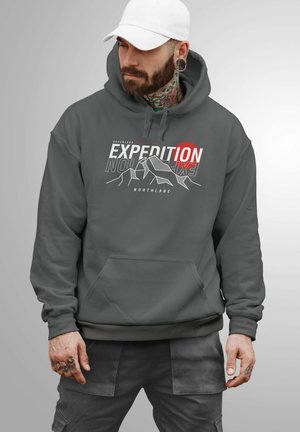 Dark gray hooded sweatshirt with graphic print featuring mountains, red circle, and text "EXPEDITION NORTHLANE." Soft fabric with a front pocket.