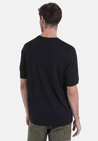 Black short-sleeve t-shirt made from soft fabric, featuring a crew neck and relaxed fit. No visible logos or patterns.