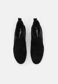 Scarpe slip-on in suede nero con punta arrotondata, pannelli elastici ai lati e un'etichetta di presa sul retro. Dimensione 37 contrassegnata all'interno.