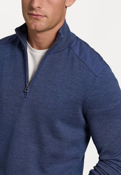Navy blue knitted sweater with zip collar, textured shoulders, and small logo on the chest. Smooth, lightweight fabric with subtle patterns.