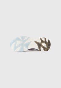 Shoe outsole with geometric tread pattern, featuring a mix of light blue, white, and brown rubber sections and textured surfaces.