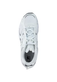 White athletic shoe with mesh and synthetic upper, padded collar, lace-up design, and gray accents. Features prominent branding on the tongue.