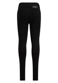 Černé legíny s úzkým střihem, vyrobené z elastického denimu. Mají dvě zadní kapsy a elastický pas s logem. Hladká textura v jedné barvě.