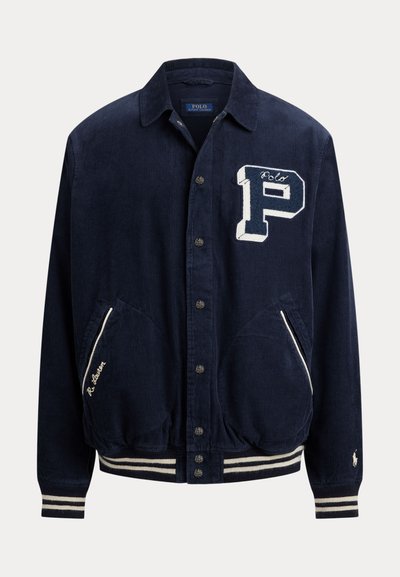 Navy blue corduroy jacket with button closure, large white "P" patch on chest, striped cuffs and hem, two front pockets with white trim.