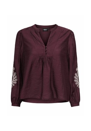 Burgundy blus med V-ringning, långa ärmar och dekorativ vit brodyr på ärmarna. Tillverkad av texturerat tyg med knappdetaljer.