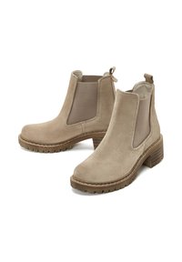 Stivaletti alla caviglia in suede beige con pannelli laterali elasticizzati, punta arrotondata e tacco impilato. Presentano un manico per indossarli facilmente. Suola in gomma testurizzata.