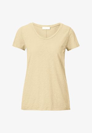 Bézs színű, rövid ujjú női póló kerek nyakkivágással és texturált anyaggal, fehér háttér előtt bemutatva.