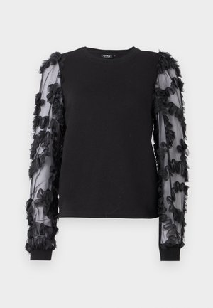 Sudadera negra con mangas largas transparentes adornadas con aplicaciones florales negras. Presenta un cuello redondo clásico y puños acanalados.