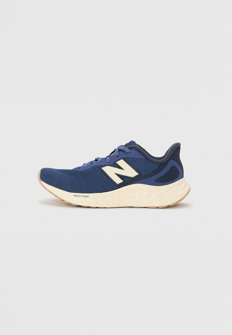 Blue athletic shoe with mesh upper, cushioned cream midsole, and rubber outsole. Features 'N' logo in white on the side.