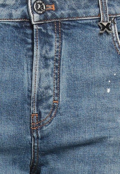 Jeans in denim blu con una vestibilità classica, caratterizzati da cuciture arancioni, una cerniera frontale e un design delle tasche arrotondato. Inclusa una bottone logo in metallo nero.
