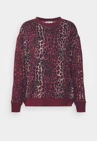 Bluza z nadrukiem w panterkę w kolorze burgundowym, z kontrastującymi solidnymi rękawami w trzy paski, okrągłym dekoltem i ściągaczami. Miękka tekstura.