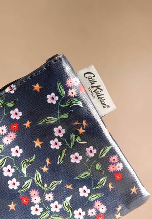 Tamsiai mėlynas užtrauktuku uždaromas maišelis, puoštas gėlių ir žvaigždžių raštais rožinės, raudonos ir žalios spalvų deriniais. Šone yra etiketė su užrašu "Cath Kidston London".